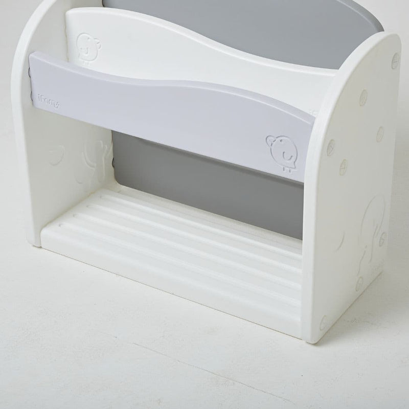 White and grey bookshelf for kids with minimal design and smooth curves.