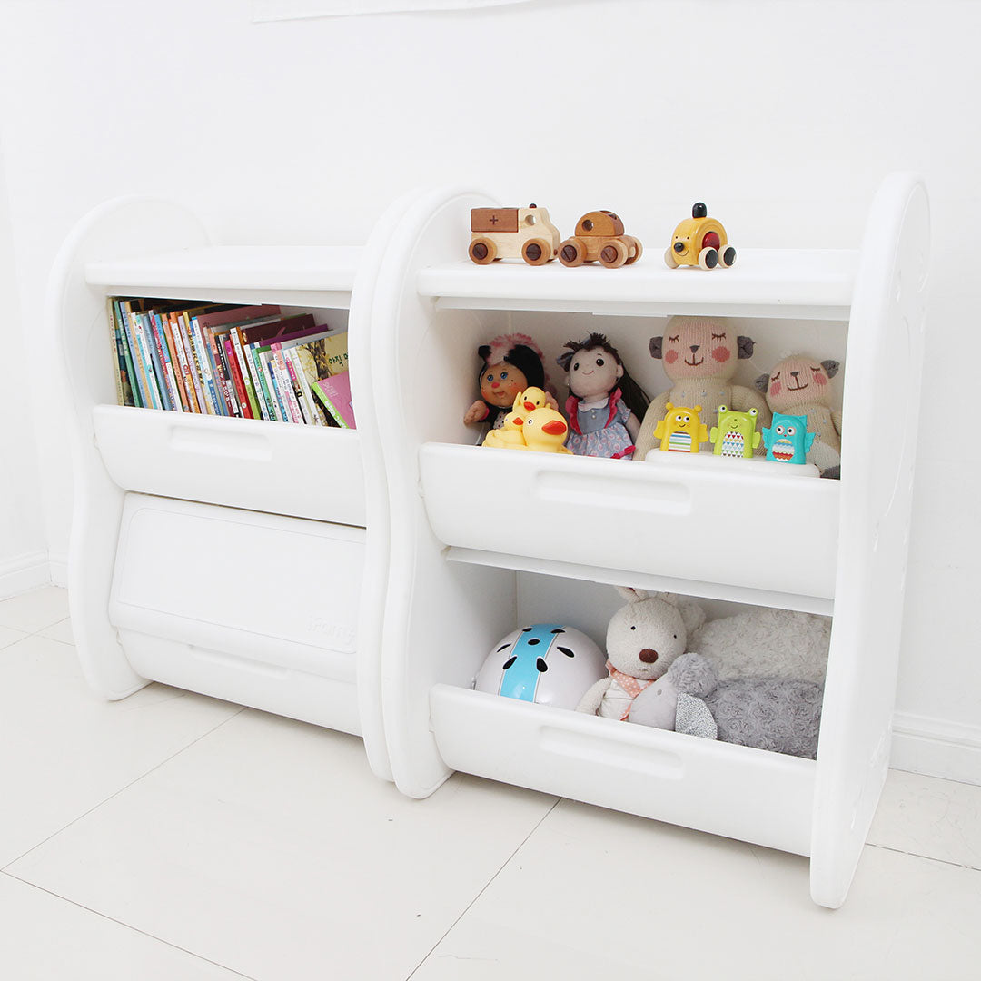 2-level children's storage organiser in white, filled with children's books and toys.